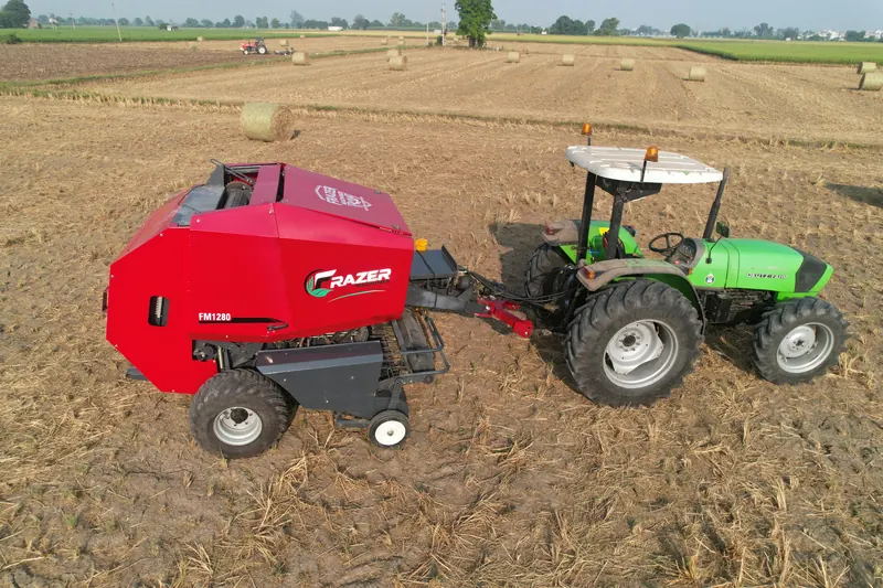 FM1280 and tractor crossing a baled field, finished bales and the horizon behind